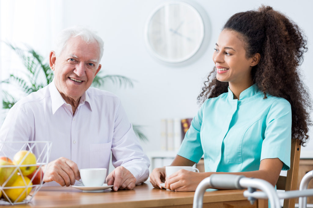 Image of positive afroamerican carer and retired man