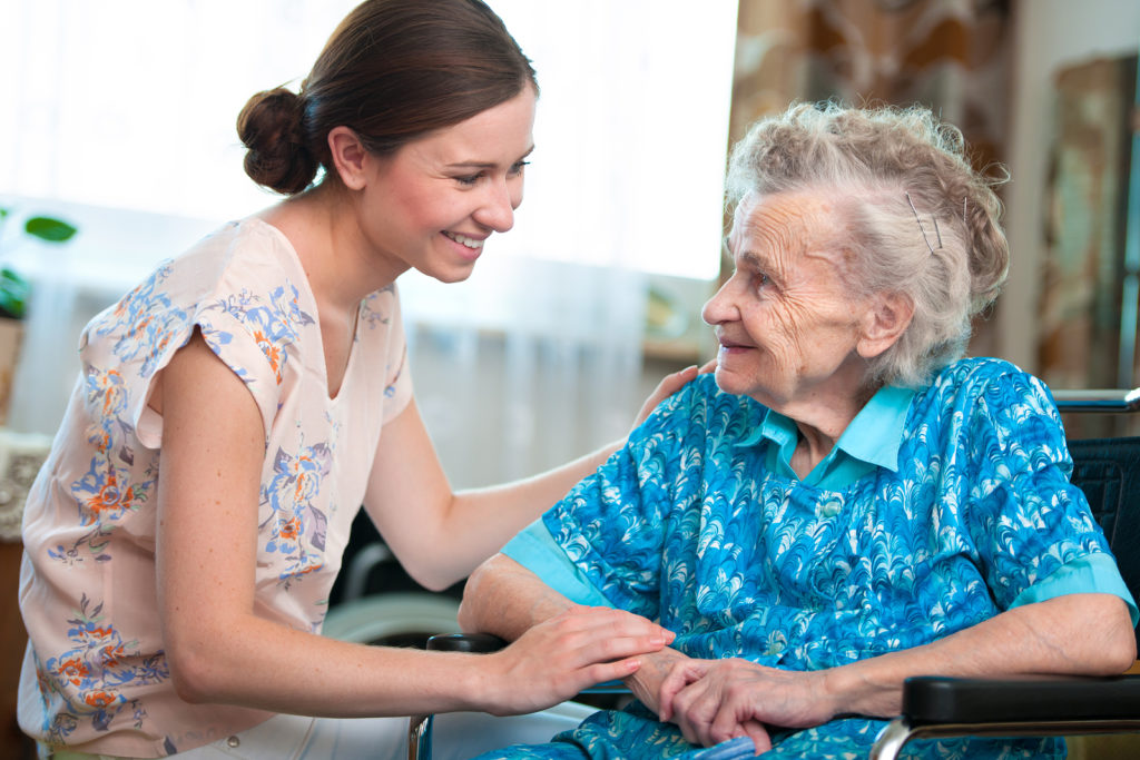 Senior woman with her caregiver at home