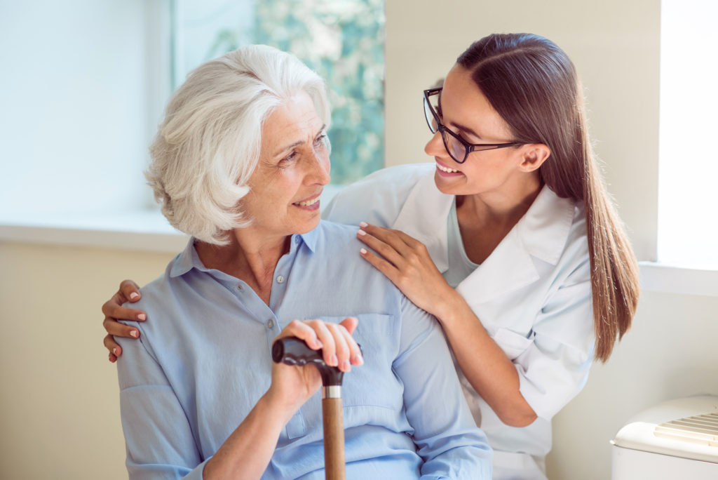 Kind one. Smiling senior woman with her home caregiver